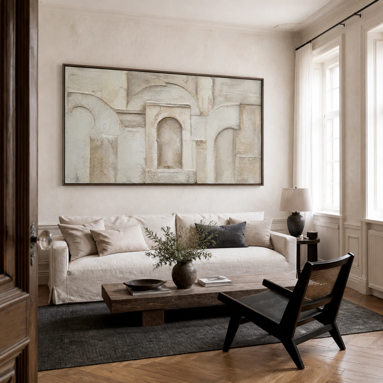 Arcade-Silence above a restrained contemporary sofa in a bright daylight living room.