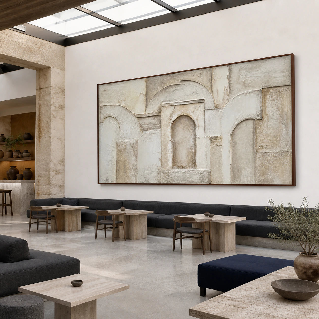 Arcade-Silence anchoring an open hospitality loft with daylight and architectural volume.