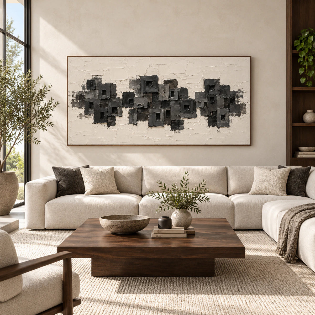 Large horizontal charcoal and ivory abstract artwork centered on a spacious architectural living room wall.