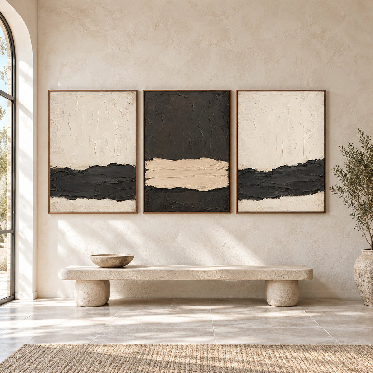 Large straight-on gallery view of the Basalt-Interlude charcoal and ivory triptych in slim walnut frames.