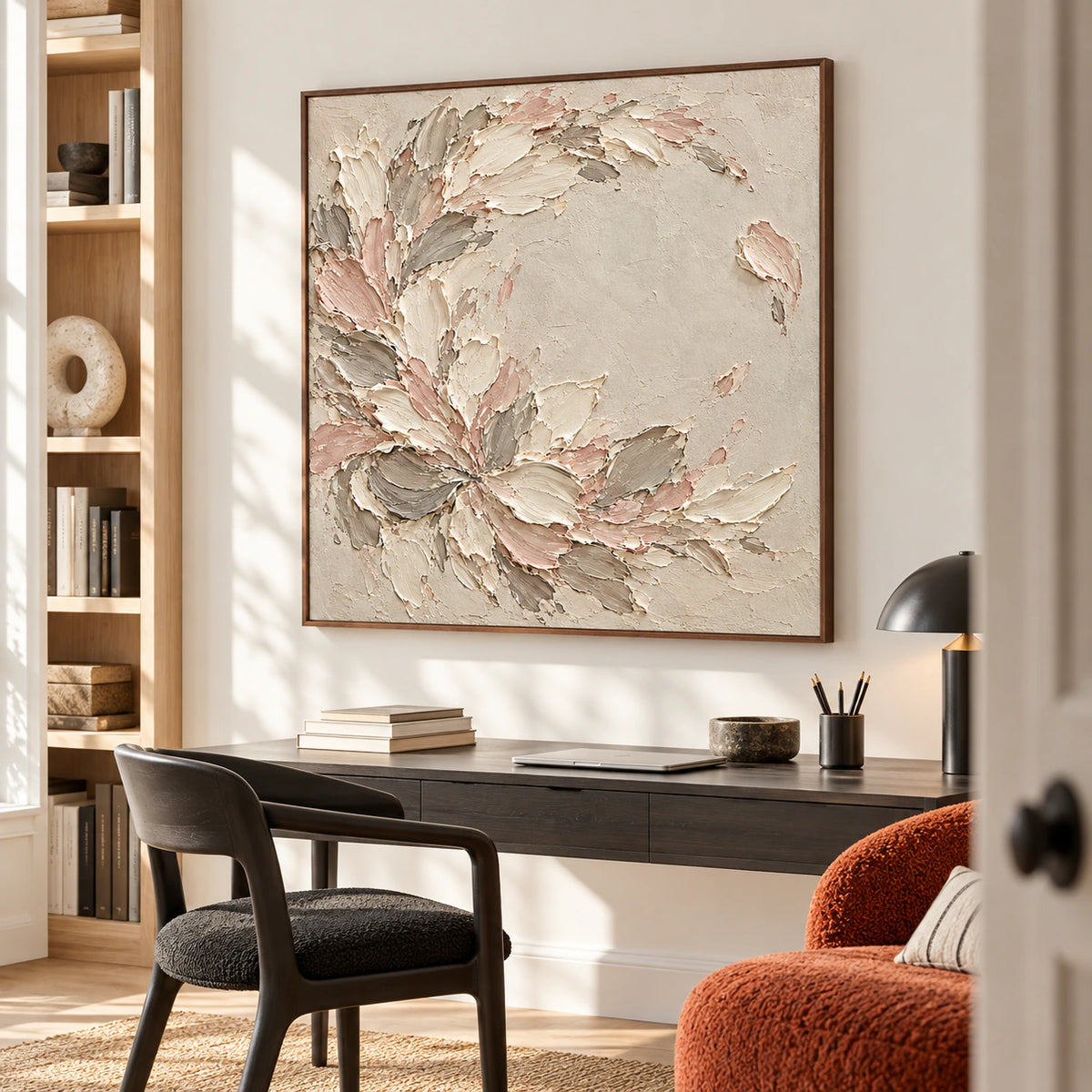 Blush-Scatter artwork beside a reading chair in an airy home office with daylight.