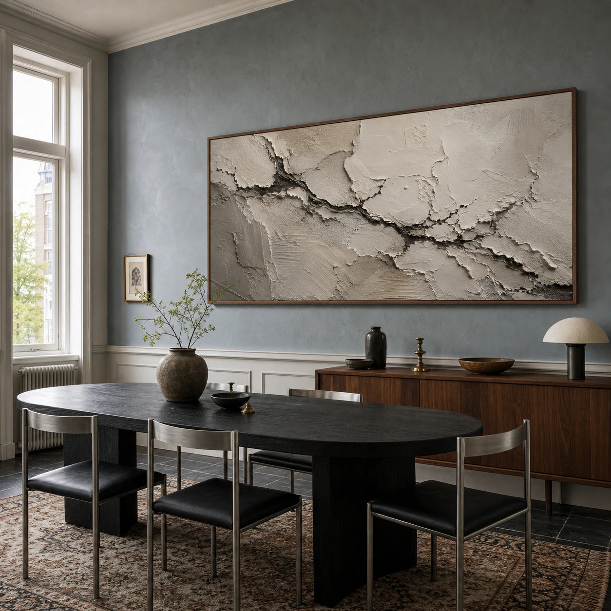 Calcite-Rift painting overlooking a black oak dining table in a refined daylight-filled dining room.
