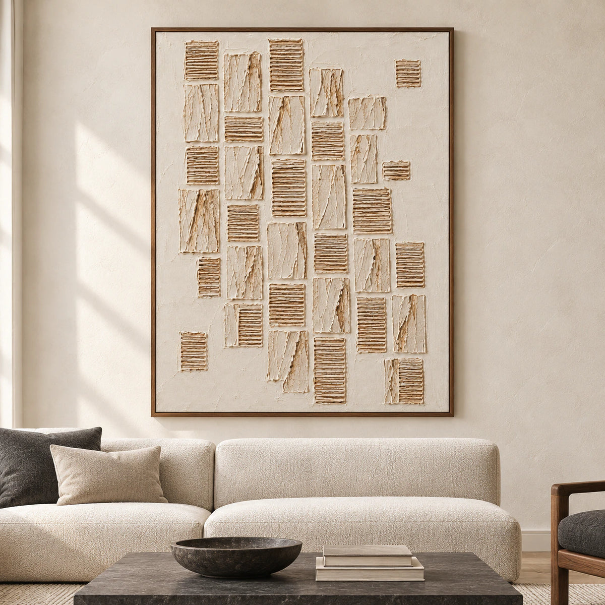 Large vertical ivory and sand relief artwork displayed prominently on a pale wall in a spacious contemporary room.