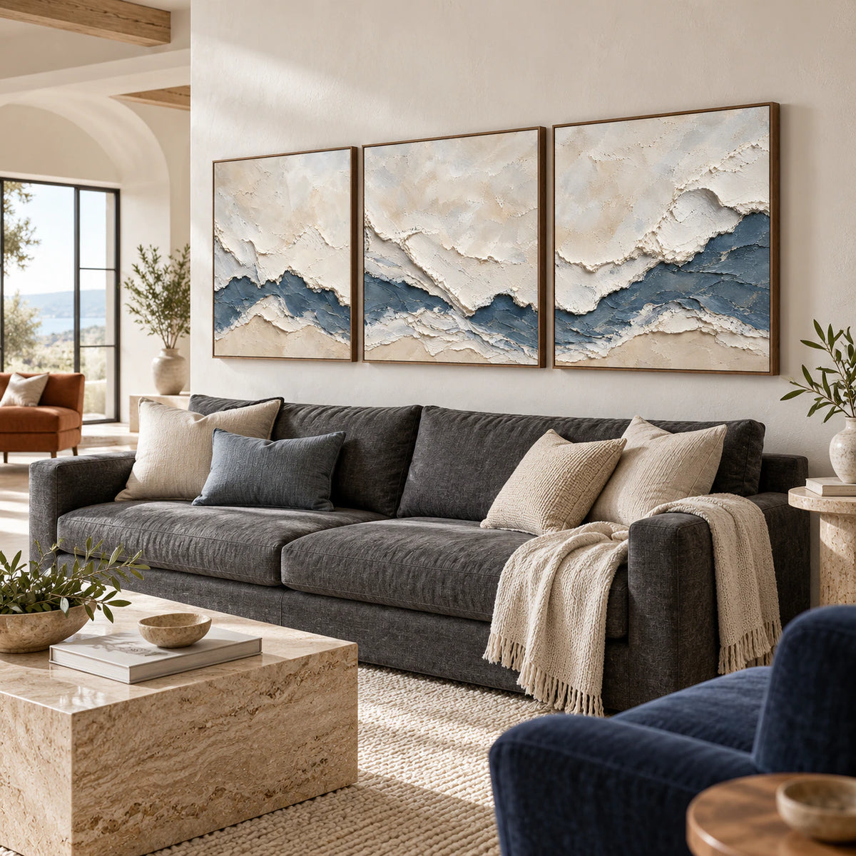 Cerulean-Sediment triptych above a sofa in a bright living room.