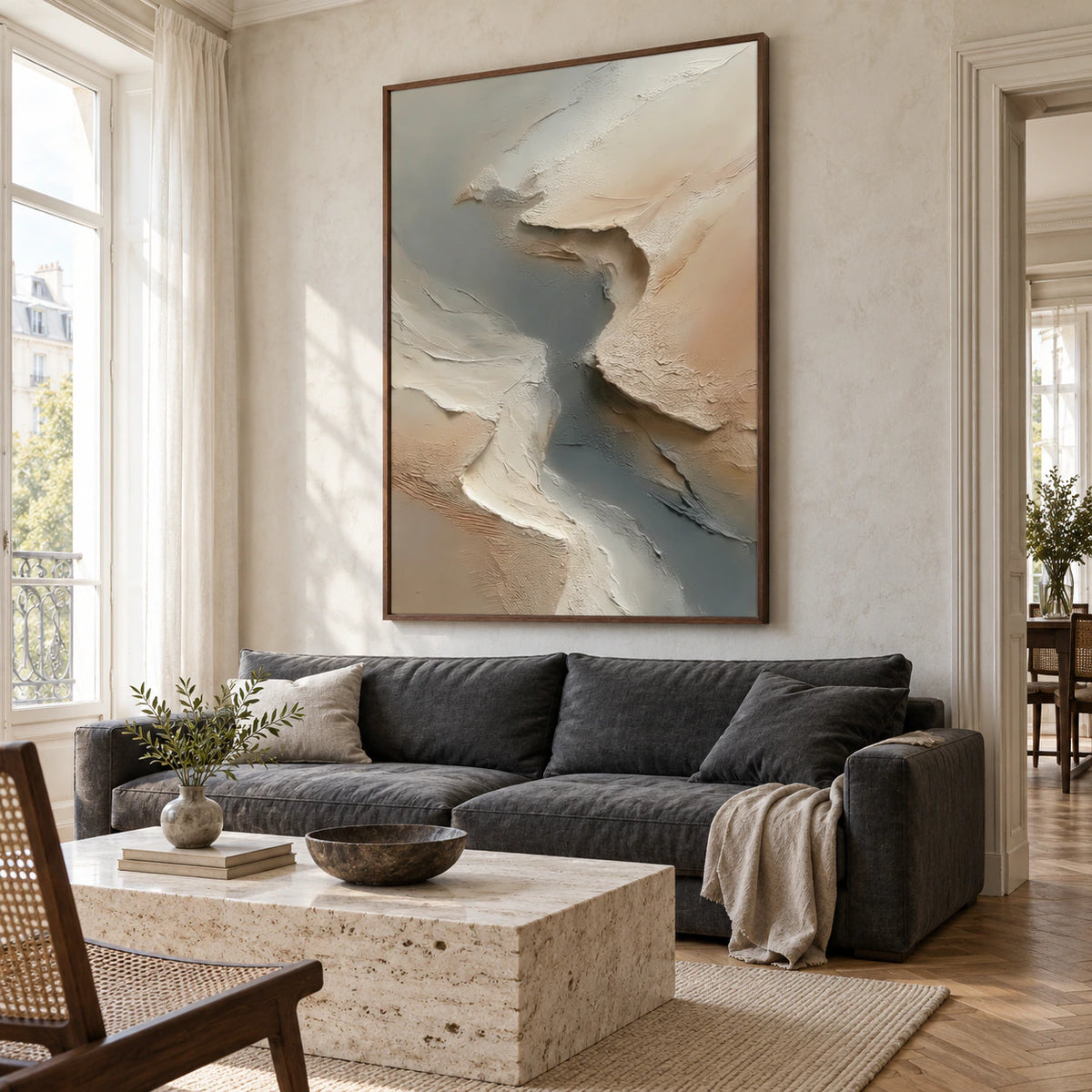 Bright living room with the vertical textured abstract painting displayed prominently above a low neutral sofa.