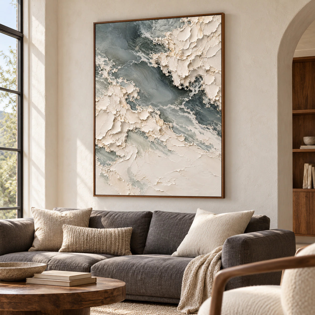 Chalkwater-Fold above a restrained sofa in a bright living room with tall windows and pale plaster walls, viewed from the left.