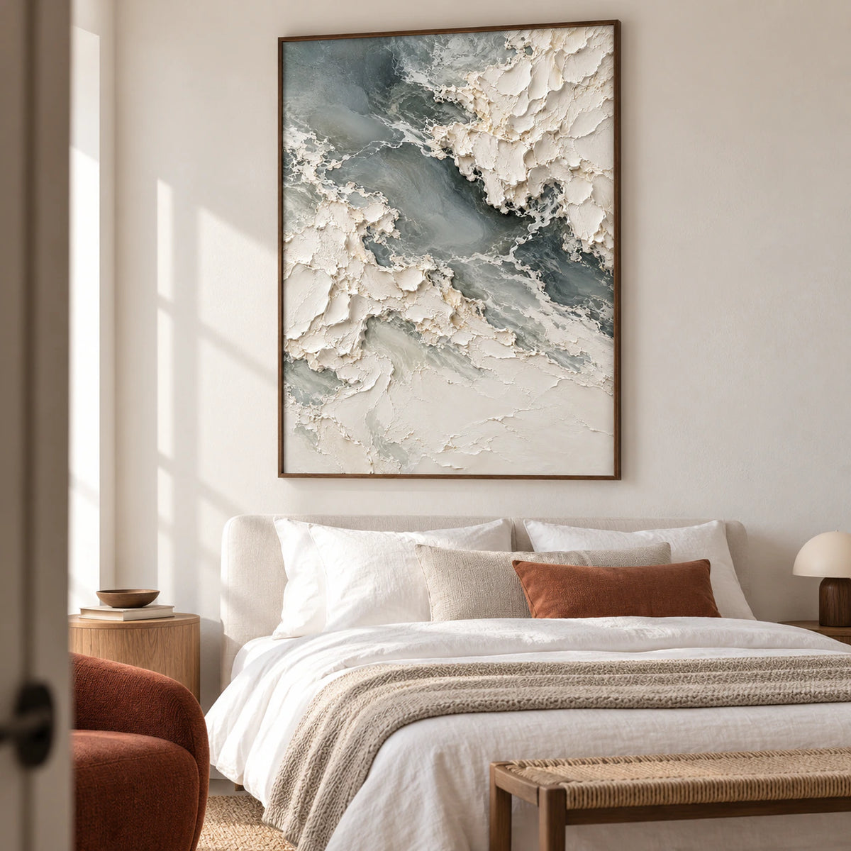 Chalkwater-Fold above a low bed with white bedding in a light bedroom, viewed slightly from the left near the foot of the bed.