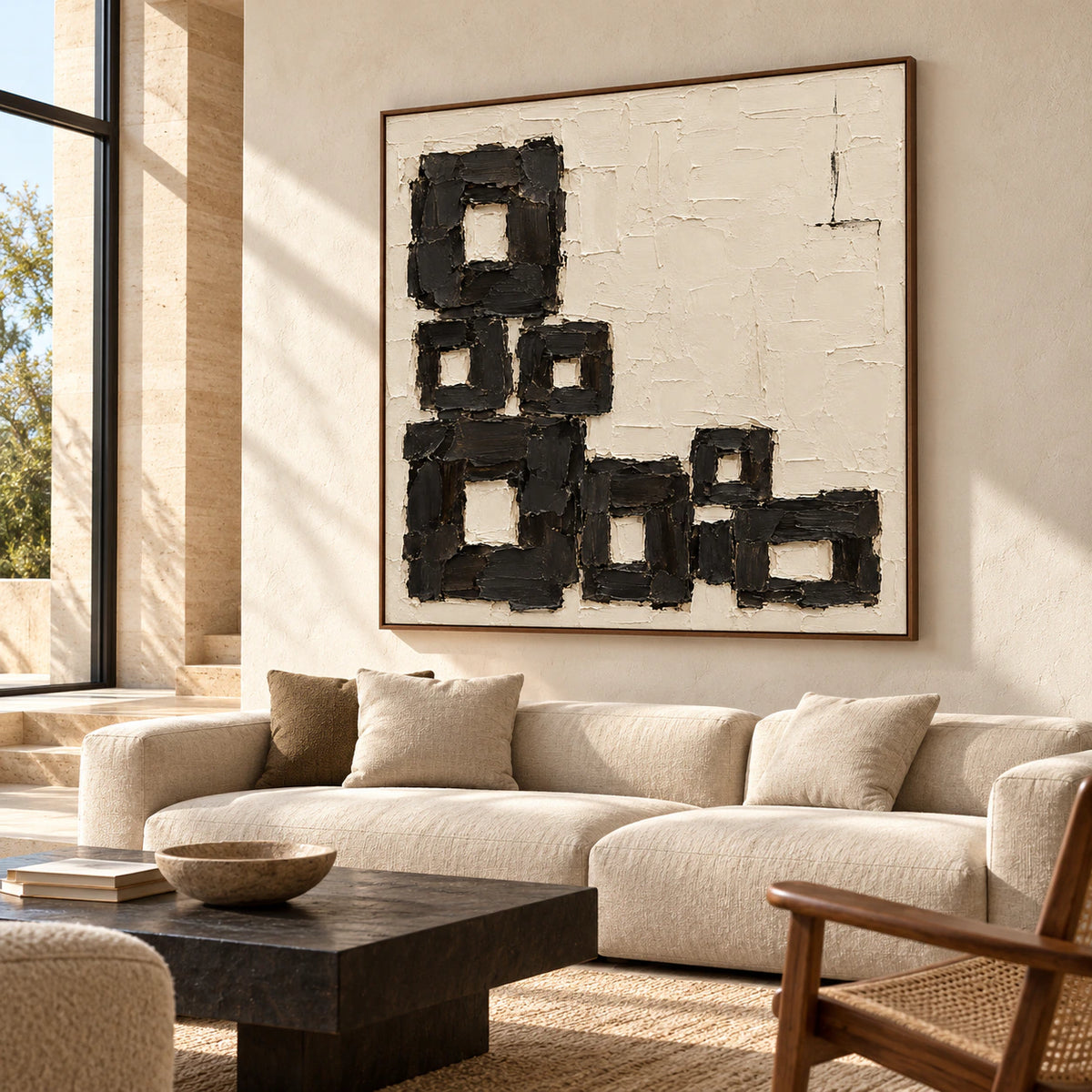 Large square Charcoal-Staircase artwork above a low neutral sofa in a bright, open living room.