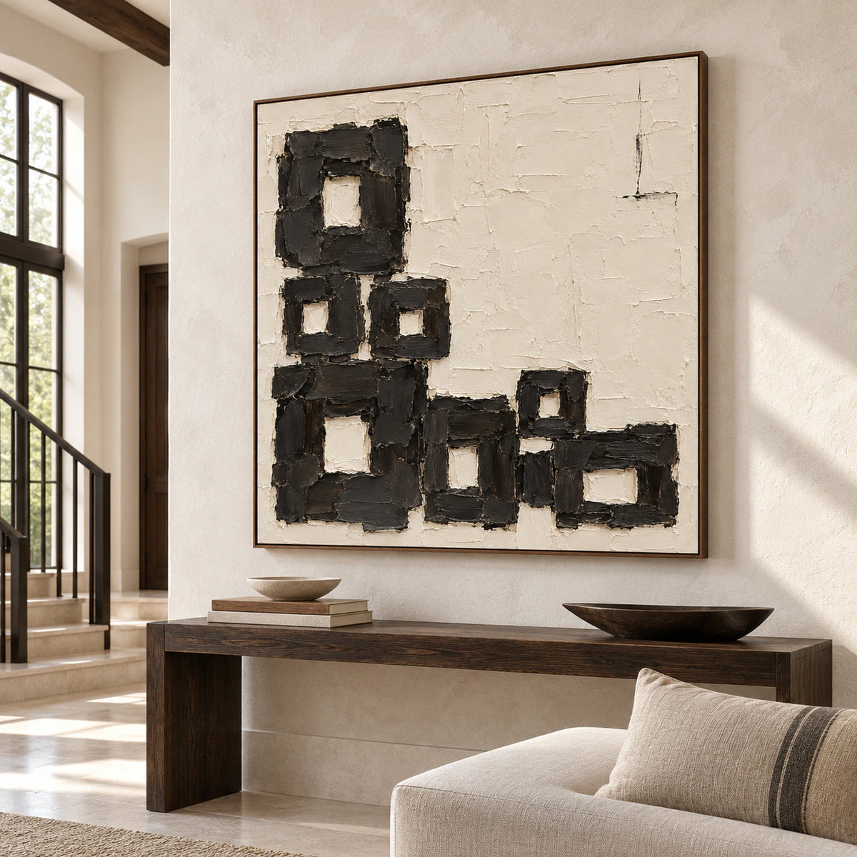 Large square Charcoal-Staircase artwork commanding a bright gallery-scale foyer with stone flooring.