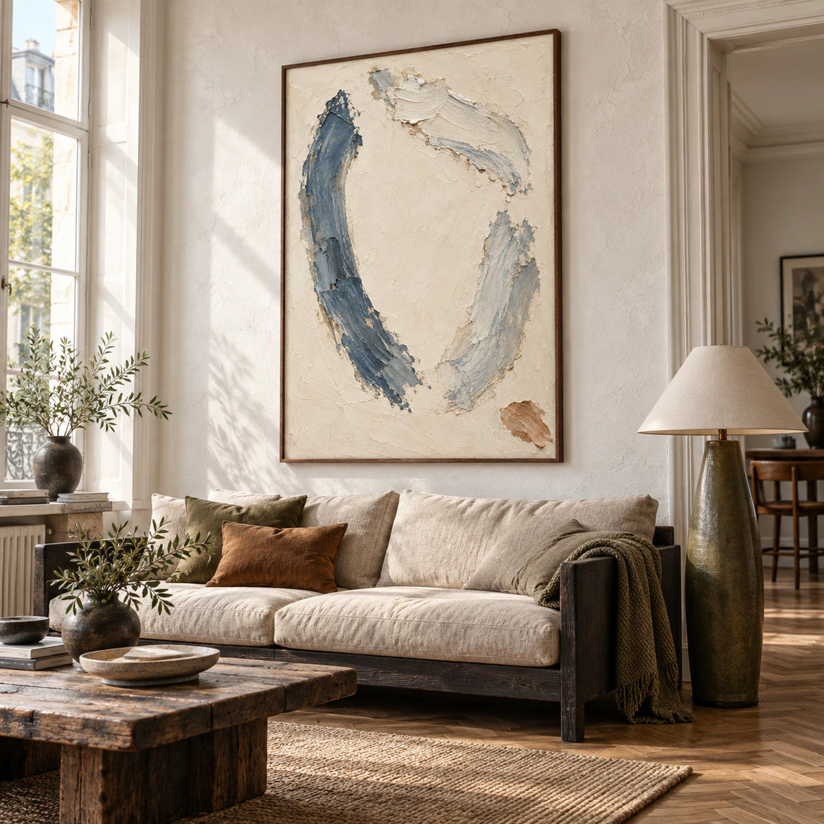 Cinder-Arc as the focal artwork above a sofa in a bright contemporary living room.