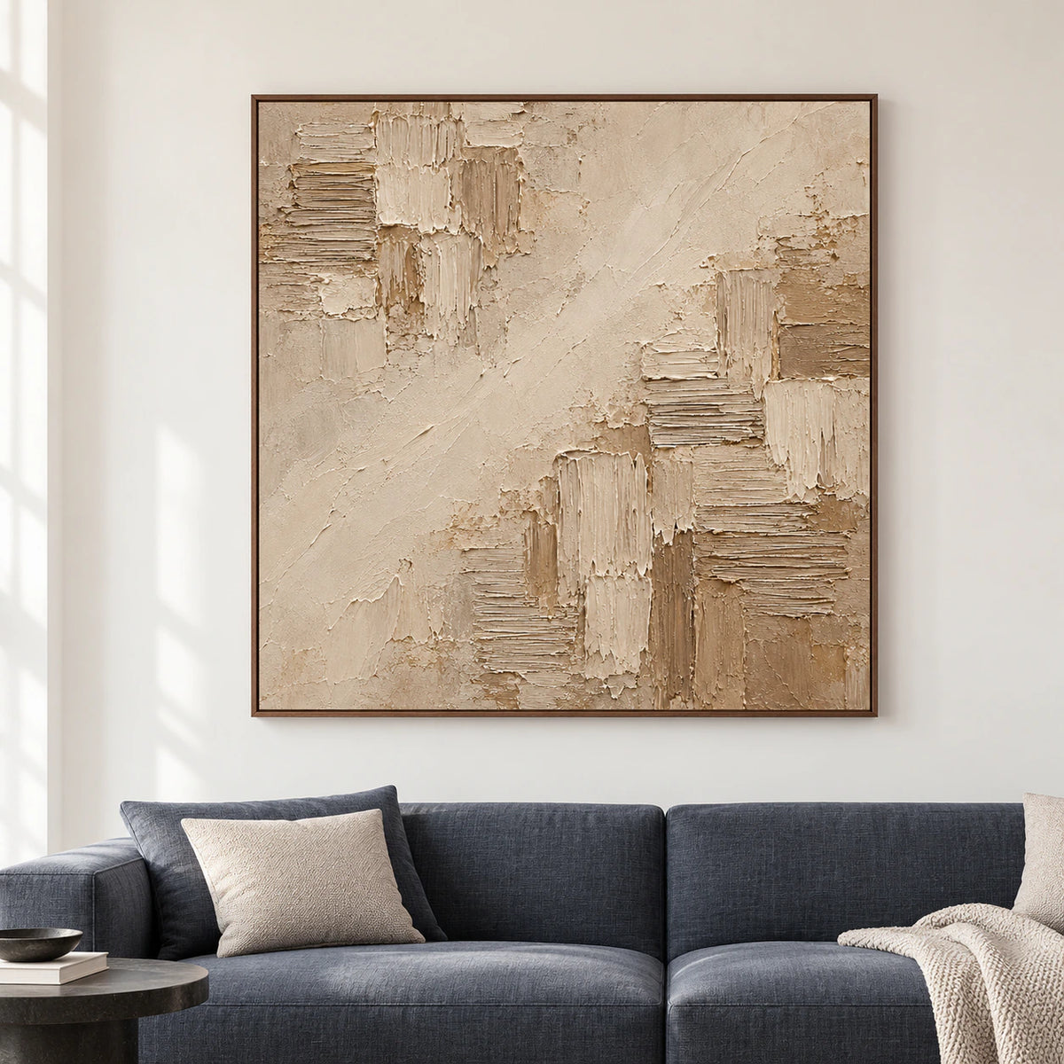 Large square abstract artwork displayed straight-on in a spacious, softly lit room; diagonal ivory-beige passages and raised combed blocks are clearly visible.