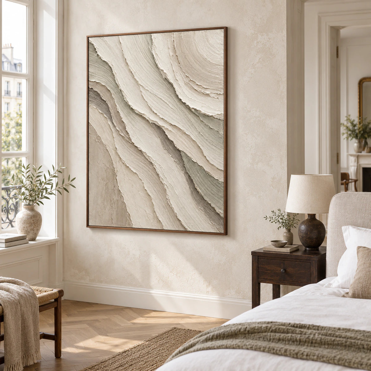 Quiet bedroom with the large layered relief artwork above a restrained upholstered bed.