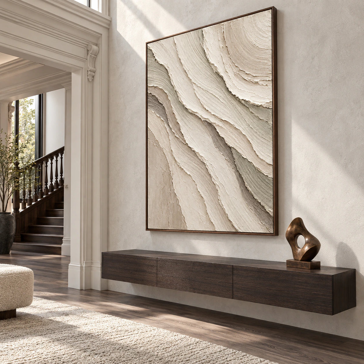 Gallery-scale foyer with the large ivory and greige relief artwork as the focal point.
