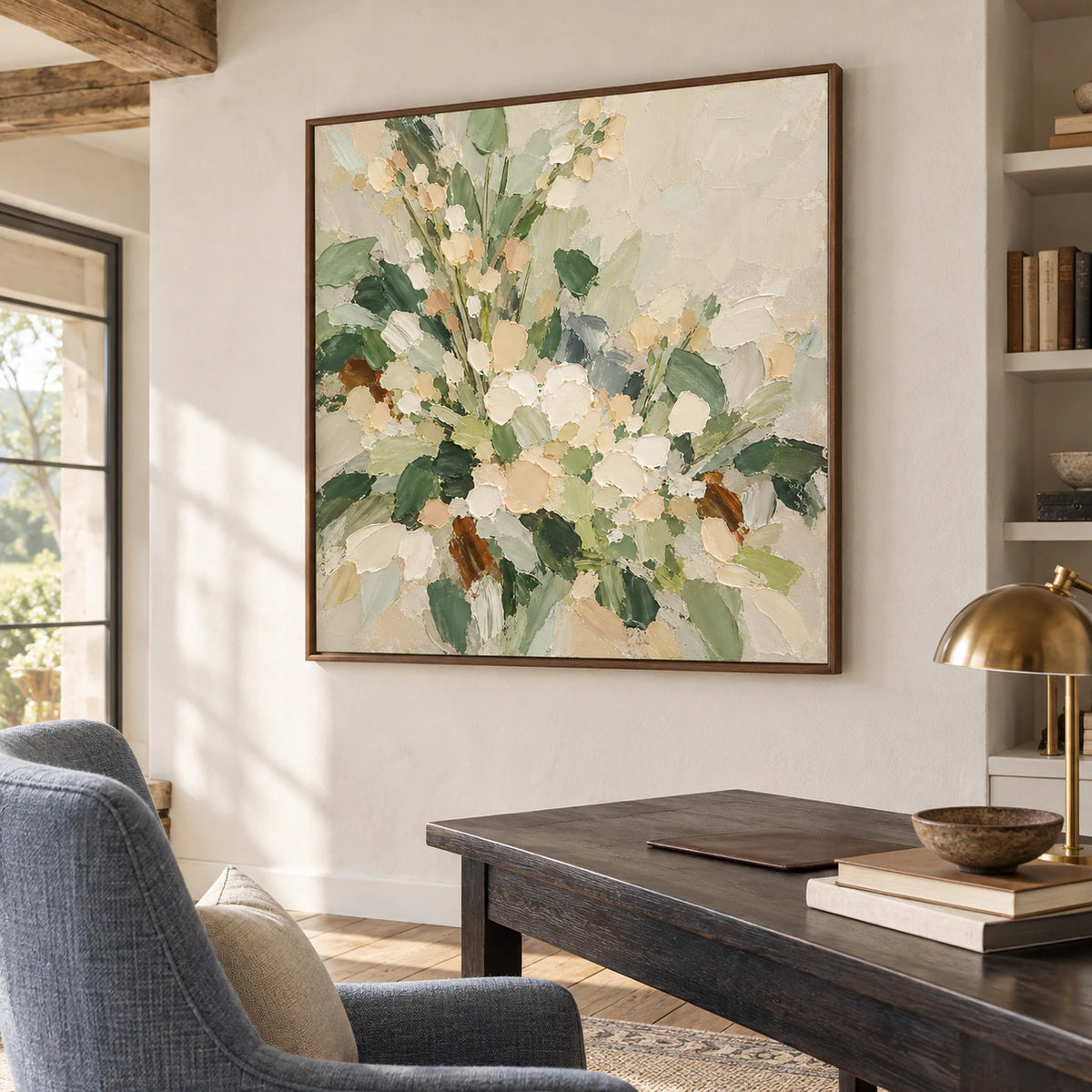 Square floral painting in an airy home office and reading space with a simple desk and open daylight.