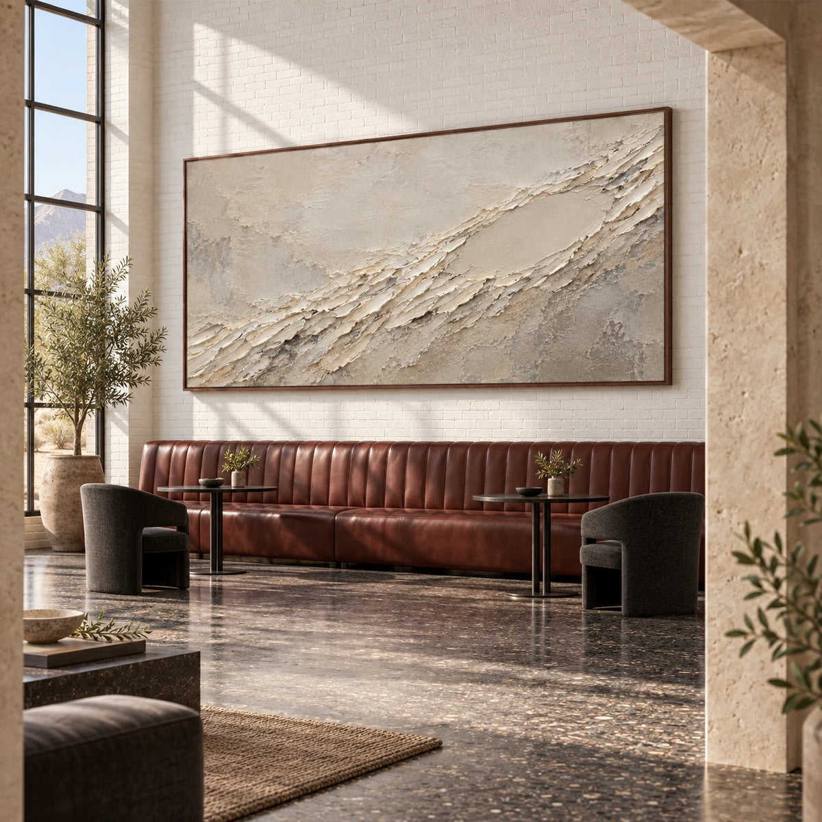 Textured ivory and gray abstract artwork in an expansive loft hospitality interior.