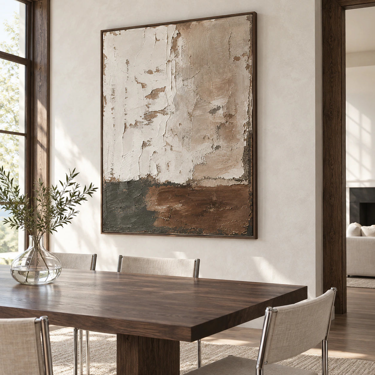 Vertical textured abstract wall art in a refined daylight dining room.