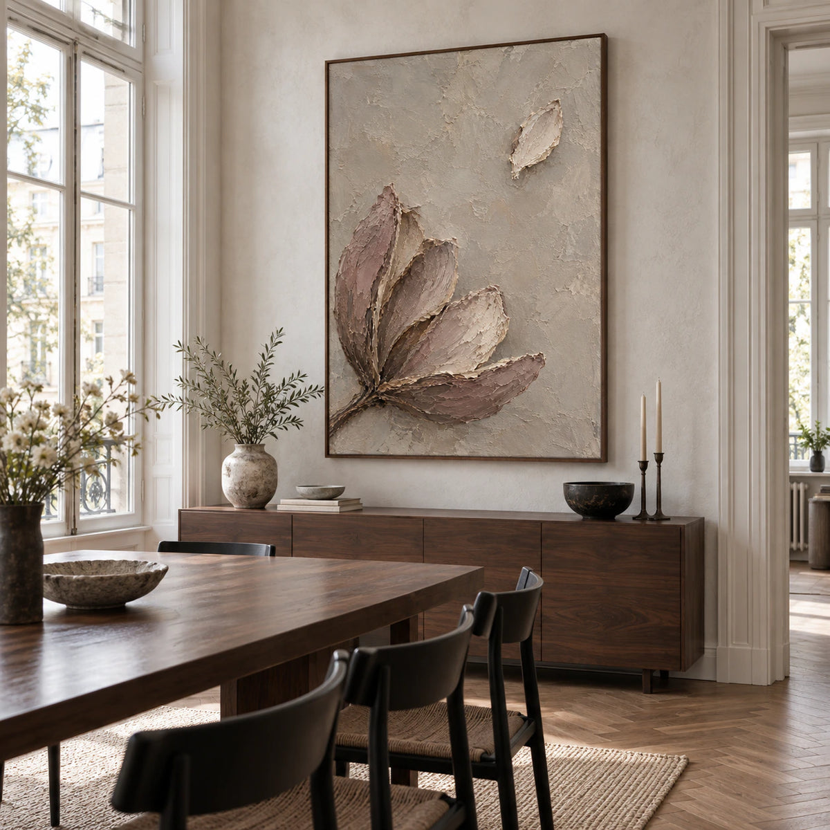 Textured botanical painting as the focal point of a refined sunlit dining room.