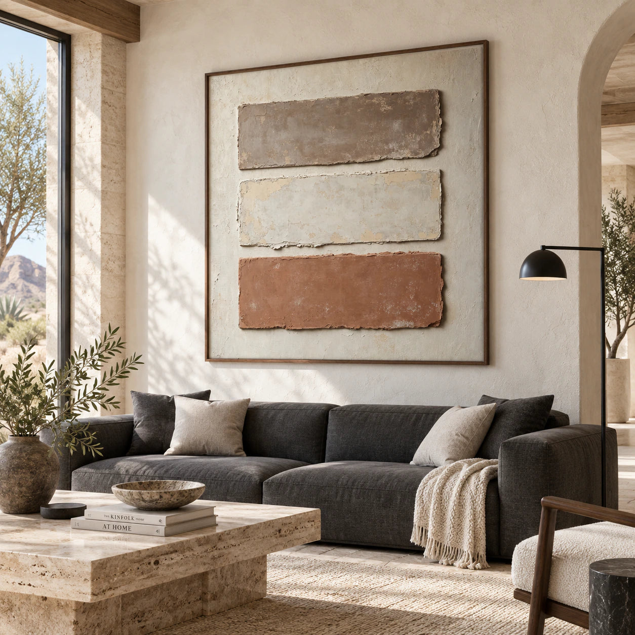 Earthen-Registers above a sculptural sofa in a bright living room.