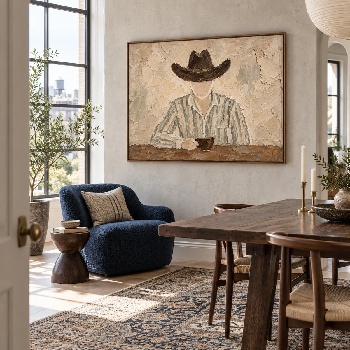 Horizontal muted figure artwork anchoring an expansive sunlit loft interior.