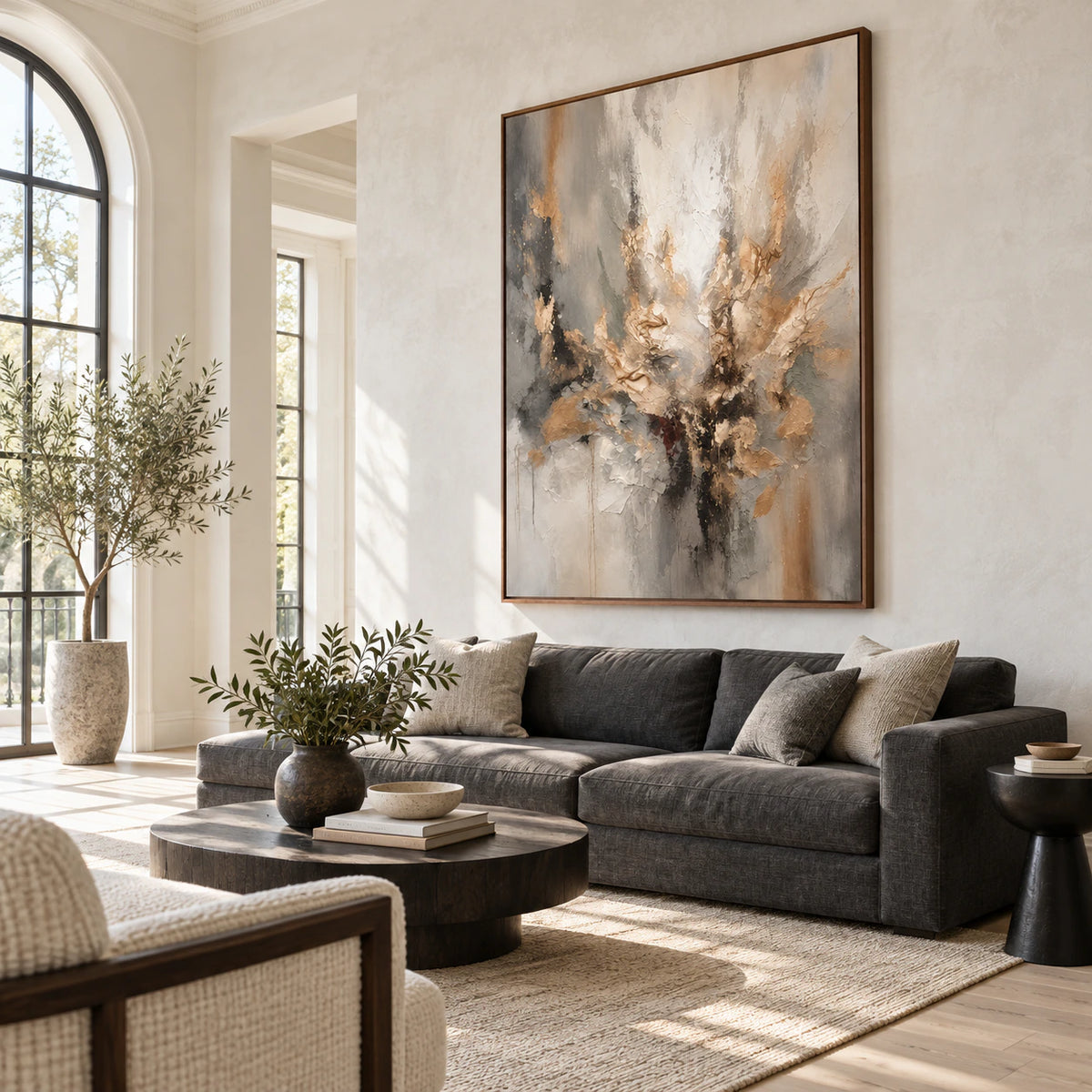 Large vertical textured abstract artwork above a restrained sofa in a bright living room.