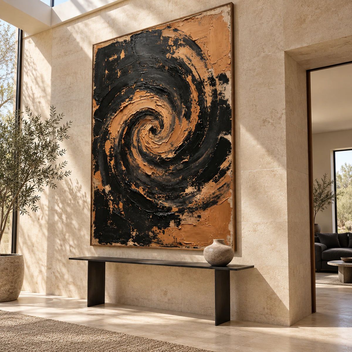 Large vertical black and ochre spiral painting at gallery scale in a bright stone foyer.