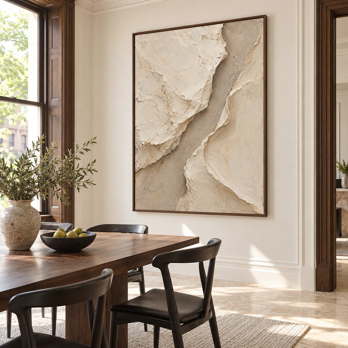 Large ivory and taupe relief painting anchoring a refined dining room with daylight and clean shadow detail.