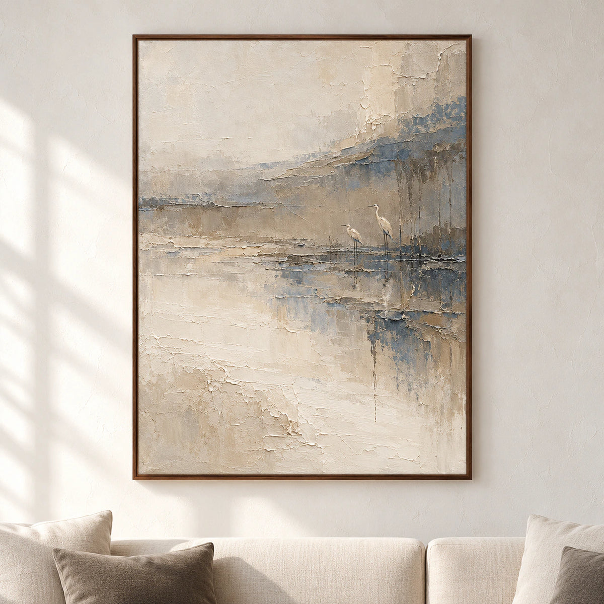 Large framed Estuary-Watch painting viewed straight on against a pale plaster gallery wall, with minimal dark furniture in a spacious, daylit room.