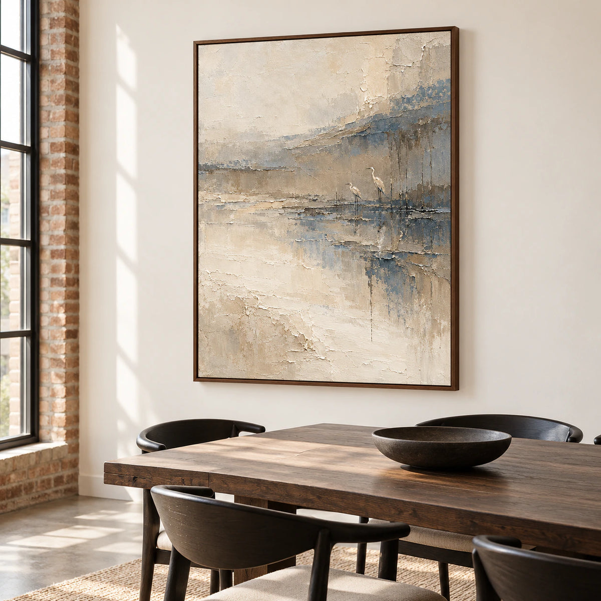 Estuary-Watch on a warm white dining room wall beside a dark wood table and sculptural black chairs, viewed from the right in daylight.