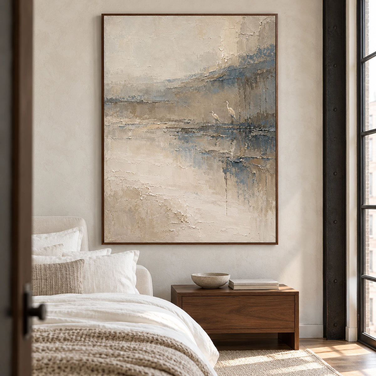 Estuary-Watch above a walnut bedside table in a pale, softly textured bedroom with white linens, viewed slightly from the left and above.