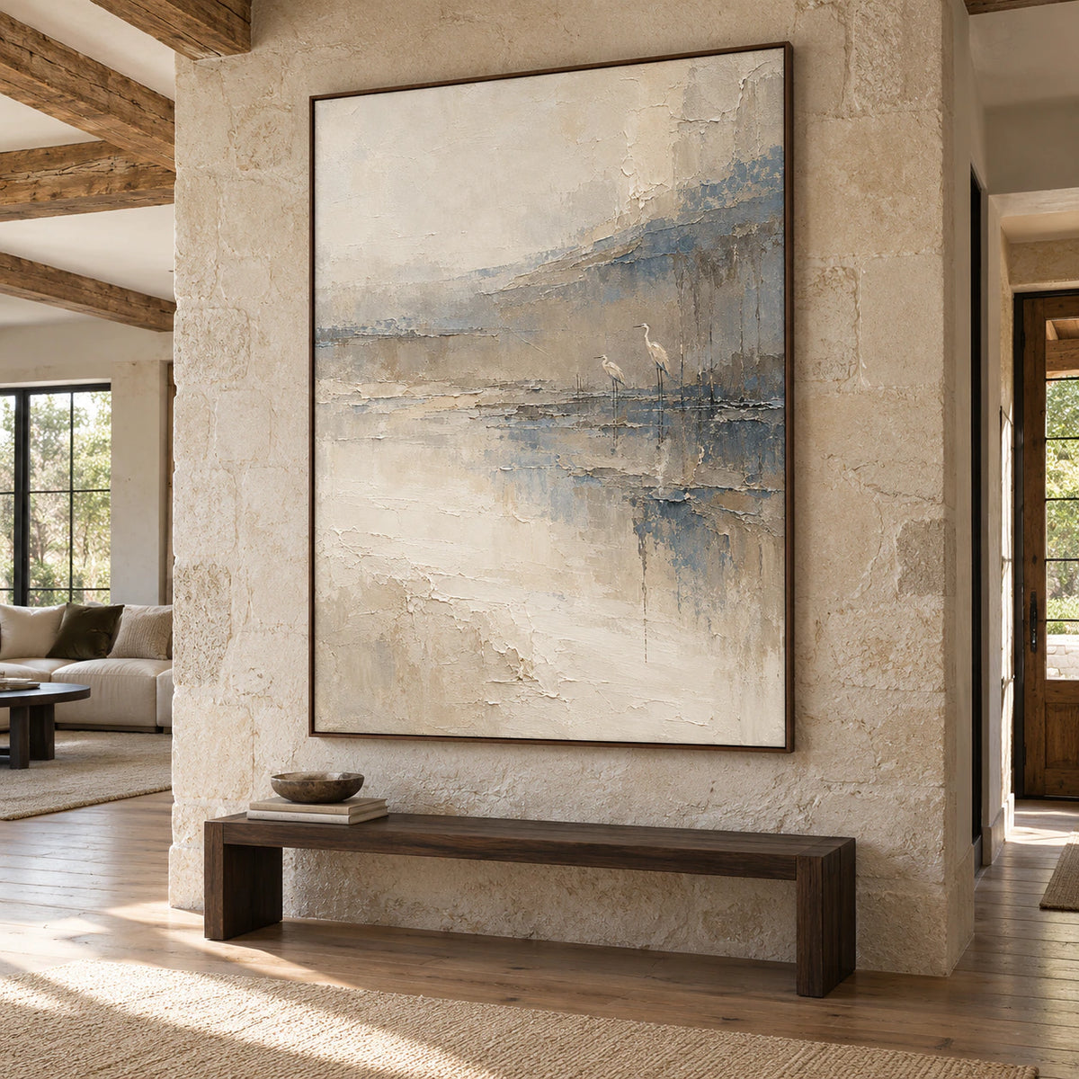 Estuary-Watch above a simple dark bench on a limestone wall in a tall, daylit foyer with wood flooring, viewed from the left at a slightly low angle.