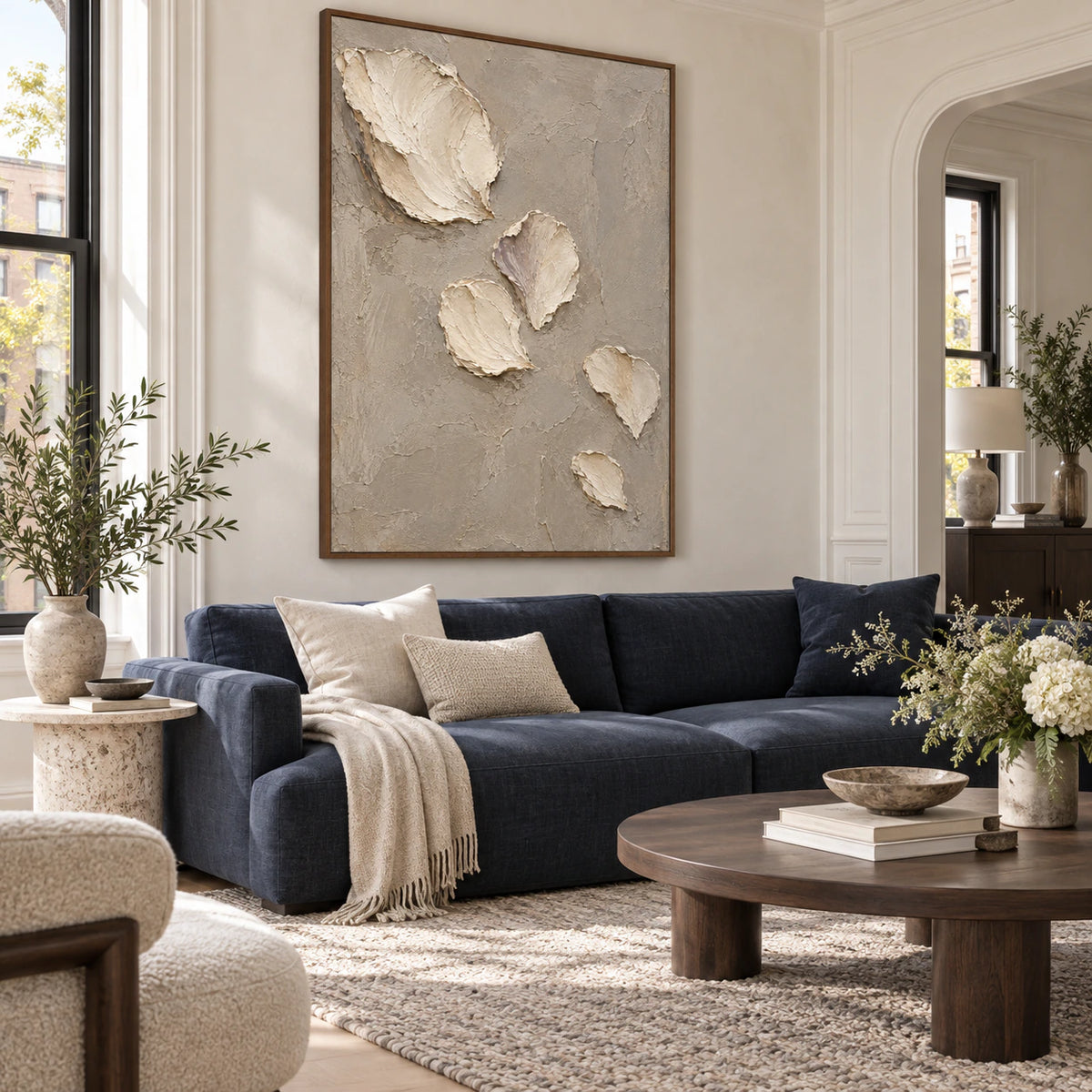 Fallen-Petals as the focal artwork above a restrained sofa in a bright living room.