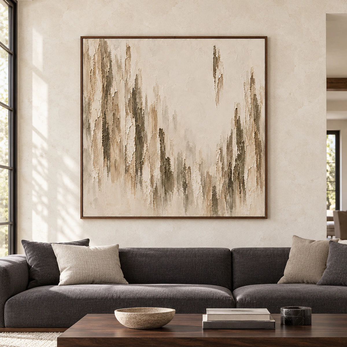 Large square abstract artwork with weathered ivory and taupe vertical ridges centered on a bright, spacious living room wall.