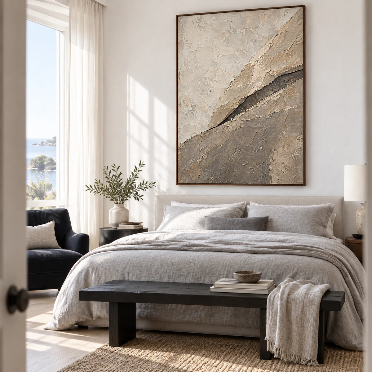 Large vertical textured abstract painting above a quiet bedroom seating area.