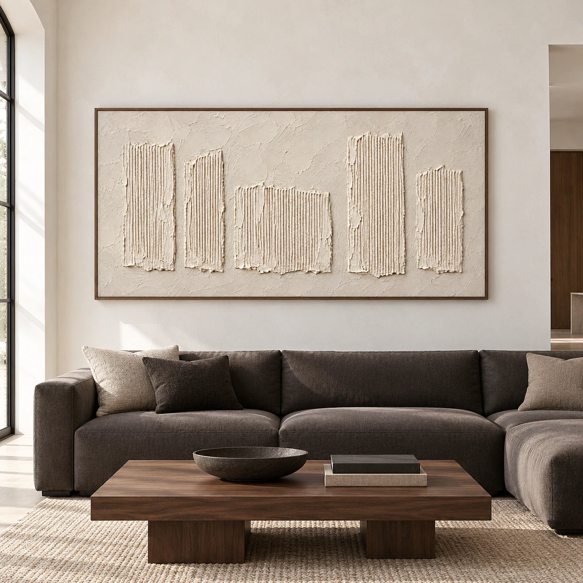 Large horizontal ivory artwork with five raised vertical ribbed forms displayed prominently in a spacious architectural room.
