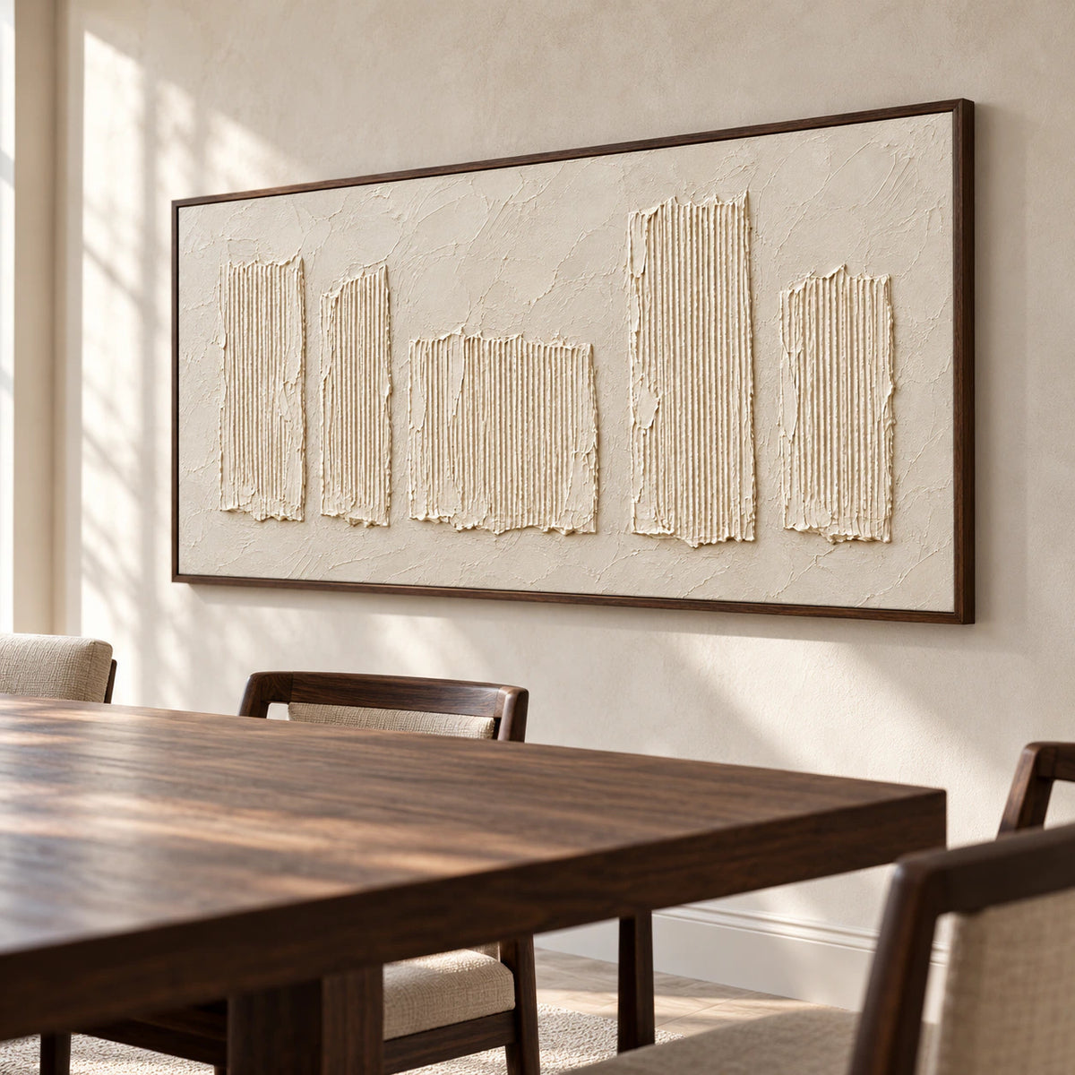 Ivory textured artwork anchoring a refined dining room with a dark wood table and restrained furnishings.