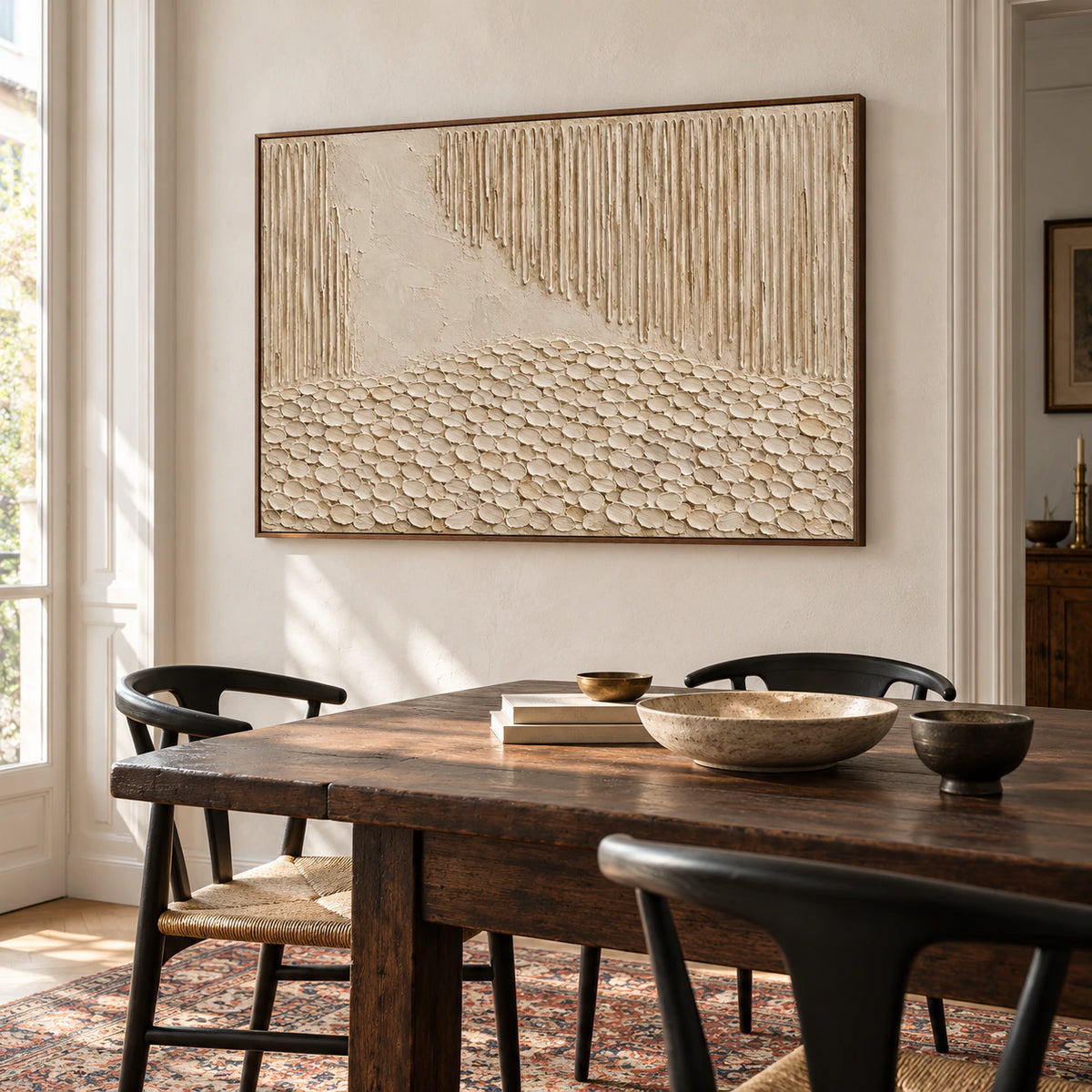 Ivory and sand abstract artwork anchoring a refined dining room with a long table.
