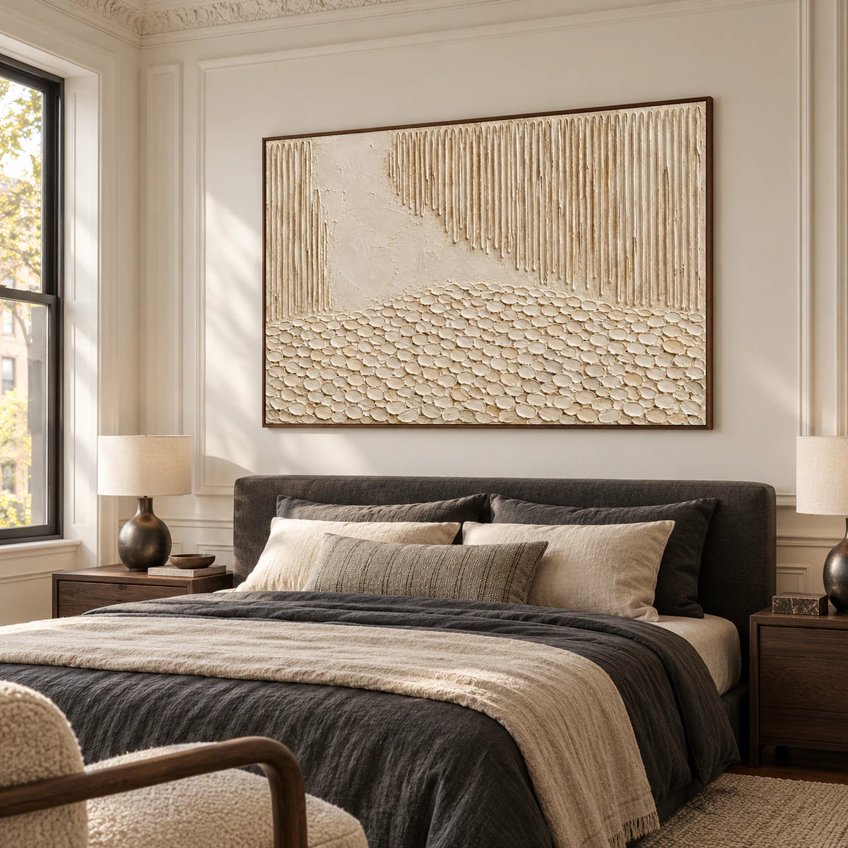 Textured ivory abstract artwork above a bed in a quiet, sunlit bedroom.