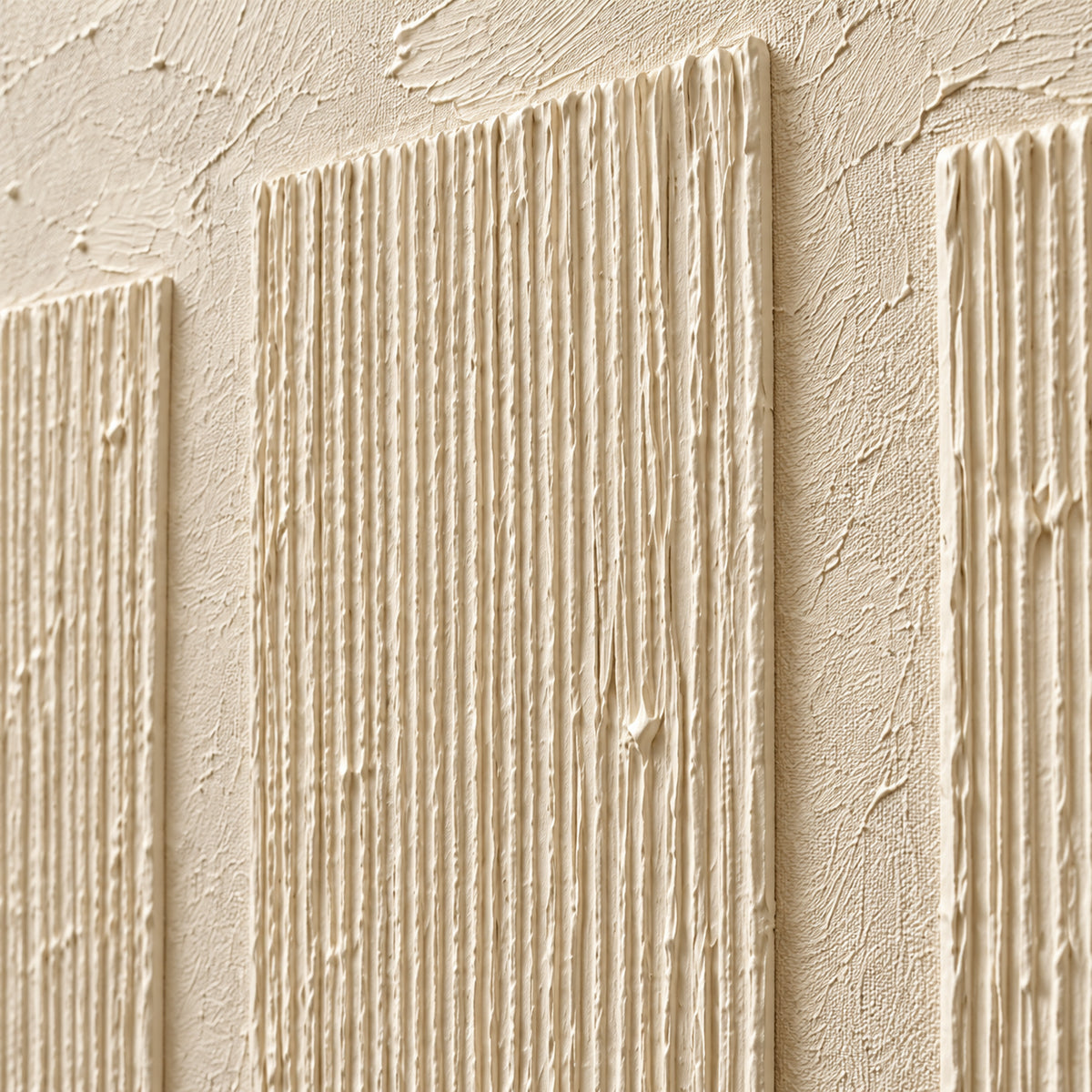 Artwork surface detail viewed close-up at an oblique angle, with grazing light revealing ivory ridges, fine surface marks and shallow shadows.