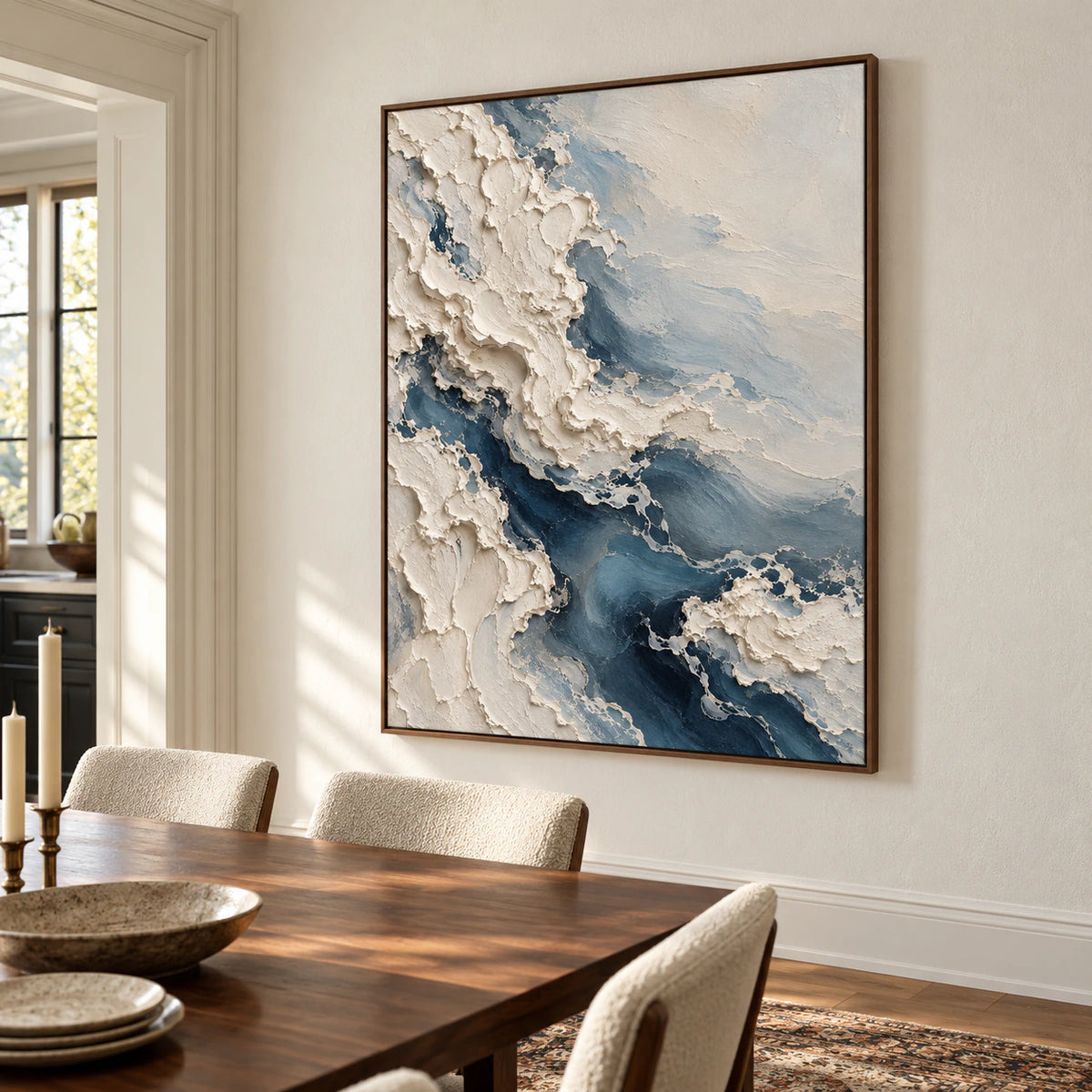 A sculptural ivory-and-blue abstract painting commands a refined dining room with a long walnut table and light-filled windows.