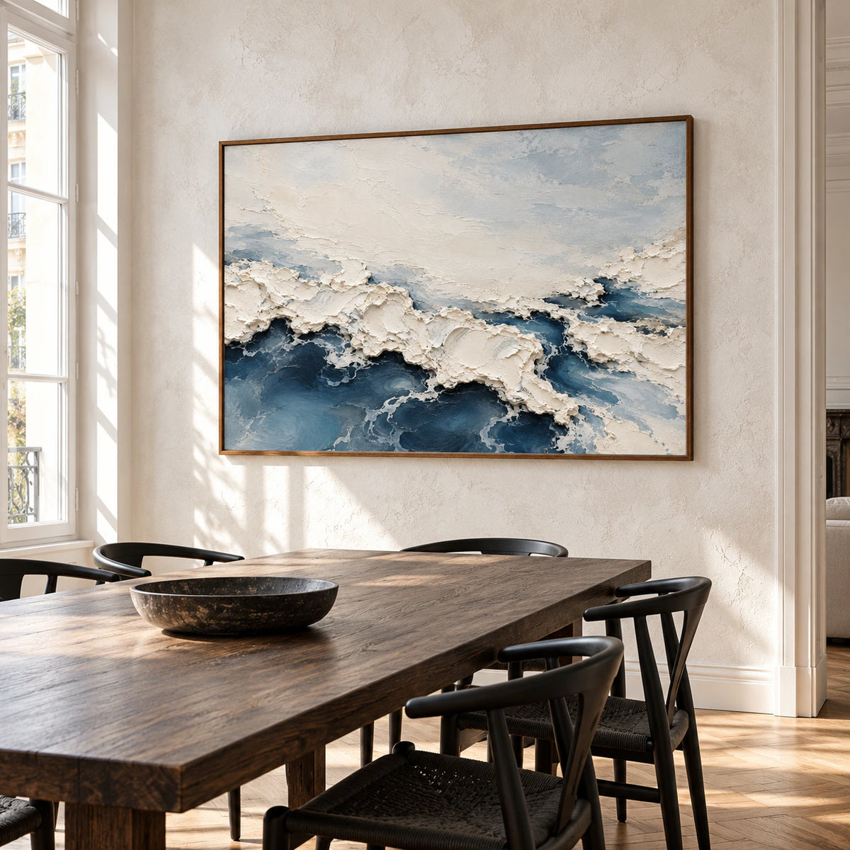 Large view of Foam Traverse in a refined dining room with a long dark oak table, pale stone walls and clear natural light.