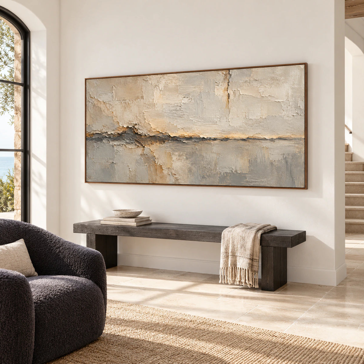 Gallery-scale Fractured Mantle artwork anchoring a bright, spacious foyer with a stone floor and minimal seating.