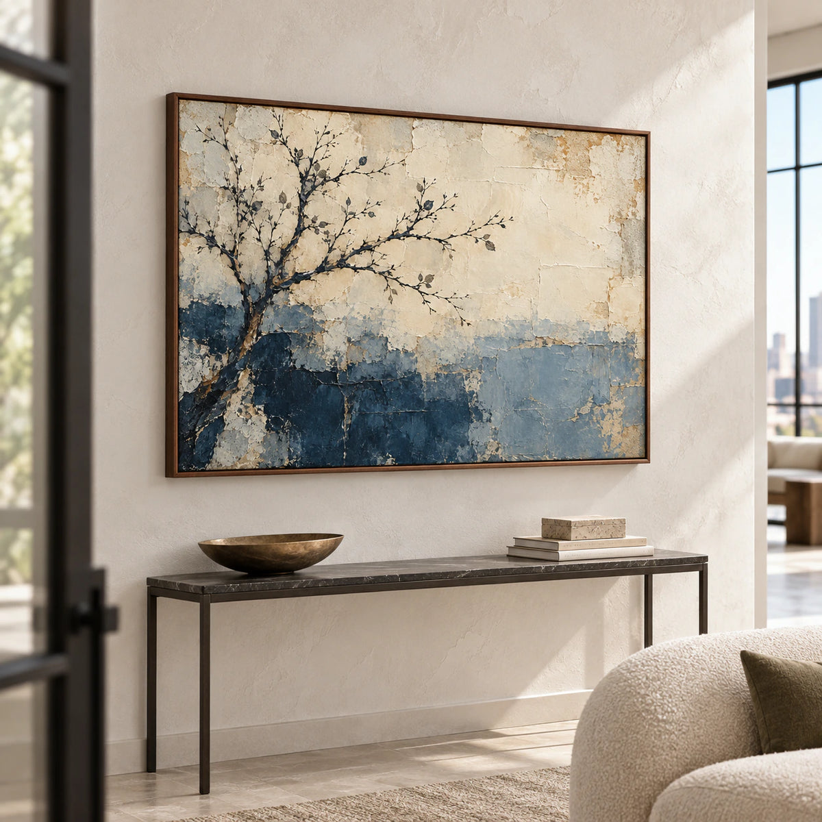 Large Frosted-Bough painting above a narrow console in a daylit foyer with tall pale walls, viewed from a left oblique angle at standing height.