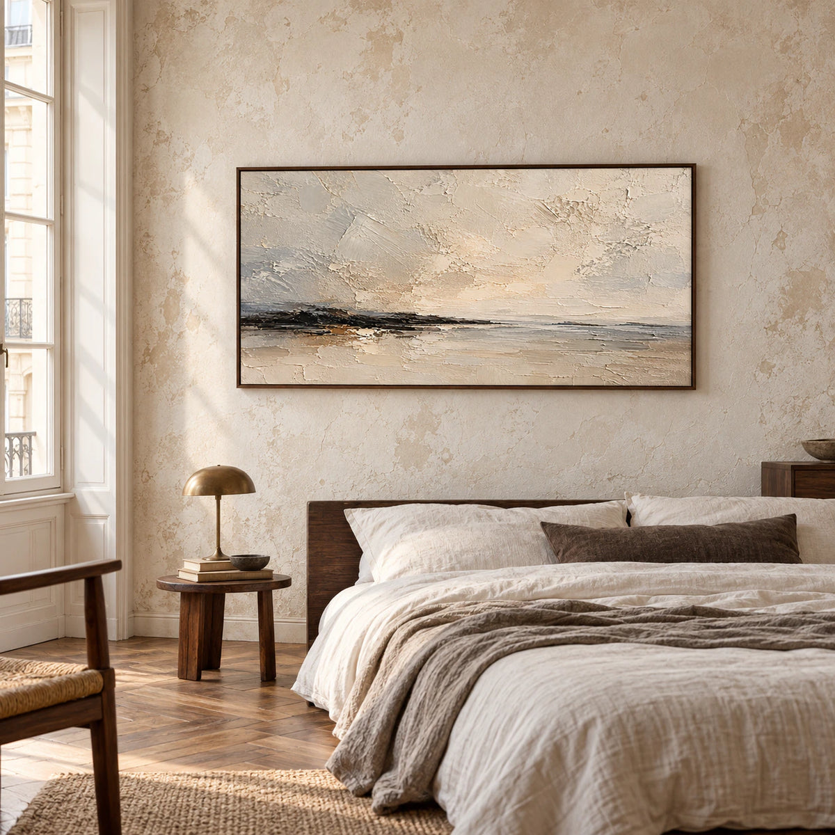 Gesso-Littoral painting above a low bed with pale linen and dark wood accents, viewed from a low, slightly rightward angle in natural daylight.