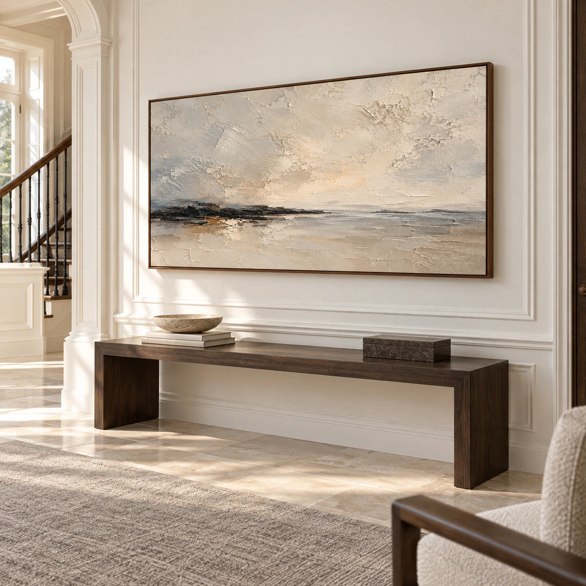Gesso-Littoral painting on a tall wall in a light-filled foyer with a stone floor and restrained furnishings, viewed obliquely from the right.