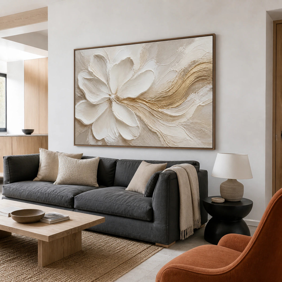 Large ivory floral abstract with a gold sweep above a bright contemporary living-room sofa.