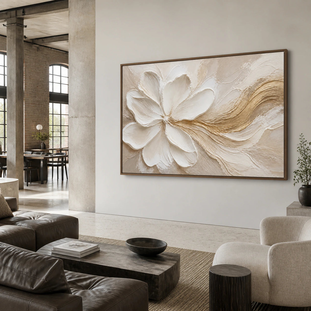 Large ivory floral textured artwork with a warm gold sweep in an open hospitality loft interior.
