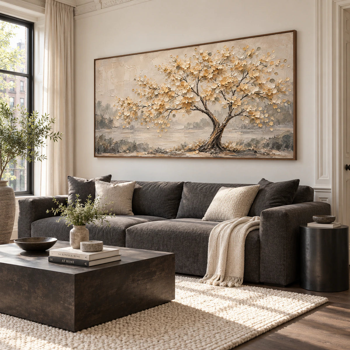 Large Gilded-Bough painting above a restrained sofa in a bright daylight living room.
