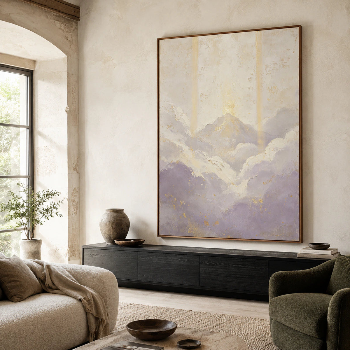 Vertical abstract mountain painting above a neutral sofa in a bright living room.