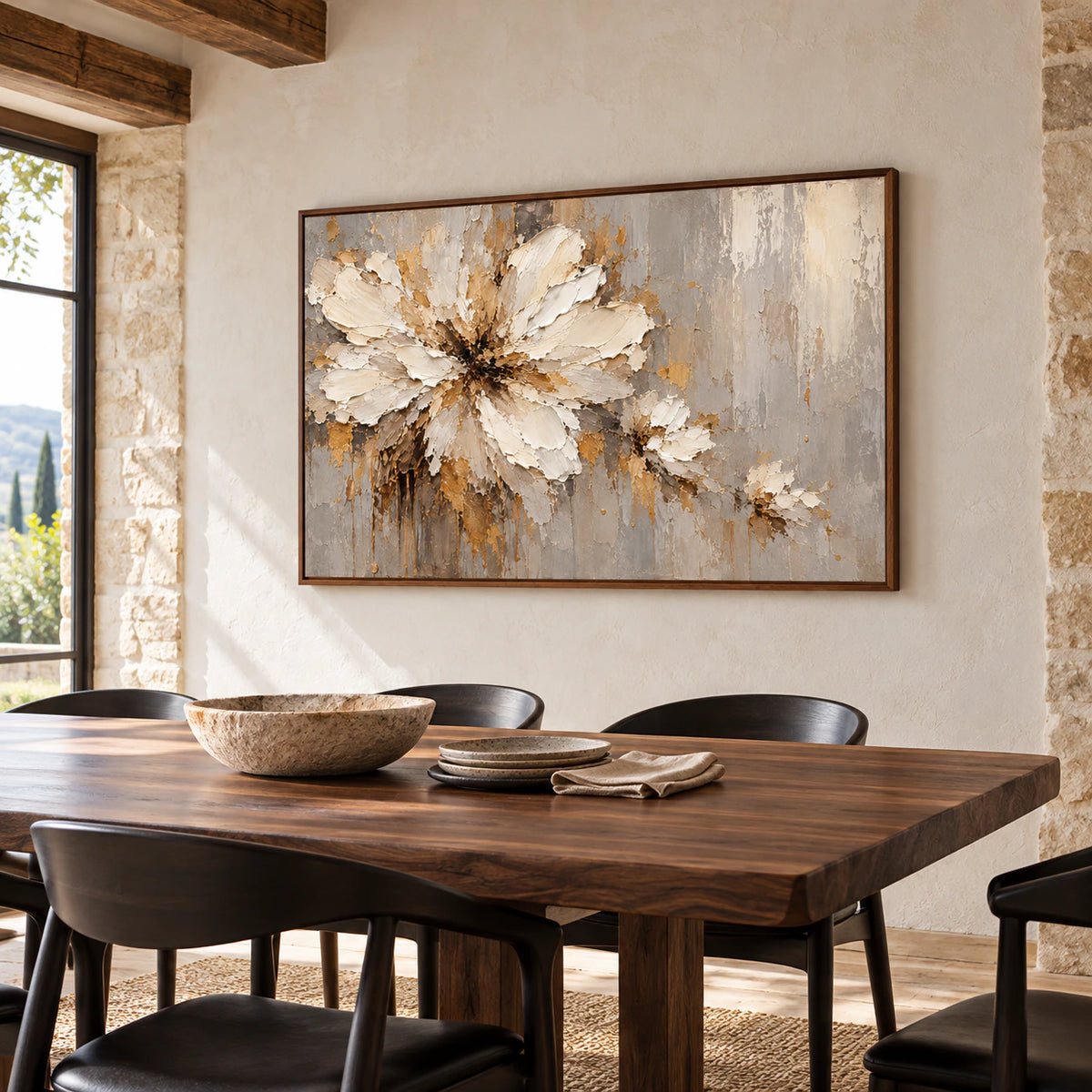 Large floral abstract painting anchoring a refined dining room with a dark wood table and pale stone walls.
