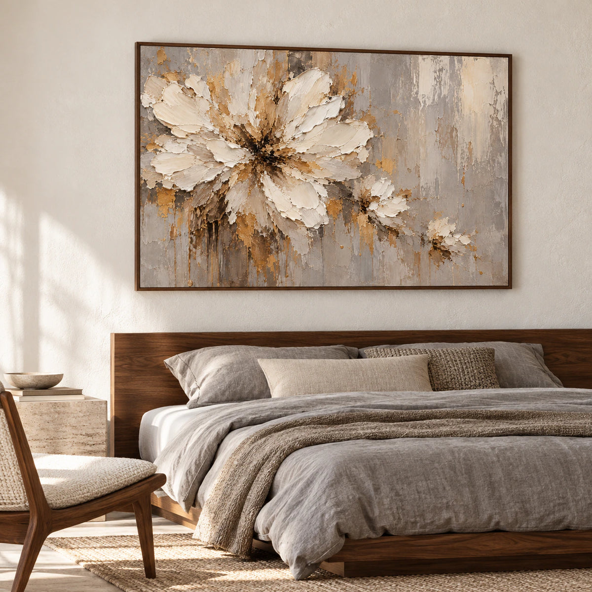 Ivory flower painting above a low bed in a quiet, naturally lit bedroom with muted linen and dark wood accents.
